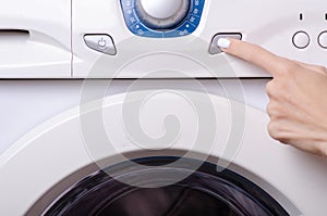 Washing machine button female hand