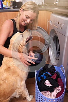 Washing machine, dog and woman with laundry in home for cleaning clothes and housekeeping. Happy, hygiene and female