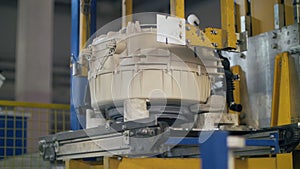 Washing machine drums moving on automatic line at manufacturing factory