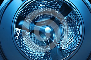 Washing machine with empty drum as background, closeup