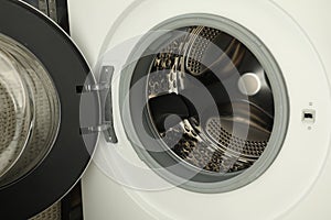 Washing machine with empty drum as background, closeup
