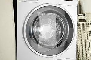 Washing machine with empty drum as background, closeup