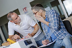 Washing machine engineer holding hand to mouth recognising mistake