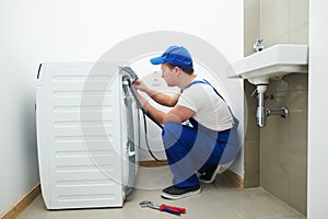 Washing machine installation or repair. plumber connecting appliance