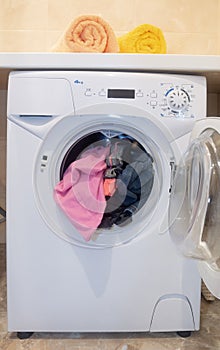 Washing machine loaded with clothes.