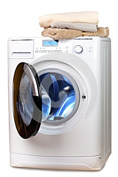 The washing machine with an open door and linen