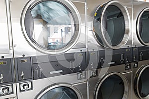 Washing machines with clothes inside at laundromat