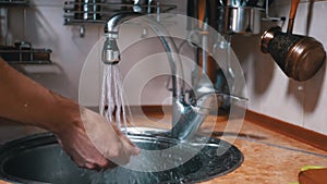 Washing male hands under a strong jet of water. Splashing. water is pouring tap