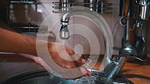 Washing Male Hands under a Strong Jet of Water. Splashing. Water is Pouring Tap