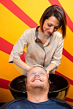 Washing man hair in beauty parlour hairdressing salon photo