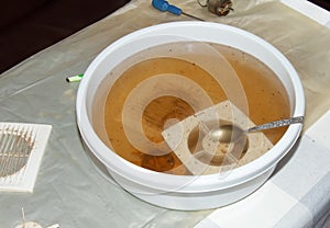 Washing the plastic parts of a very dirty kitchen exhaust fan in an aqueous solution of sodium hydroxide