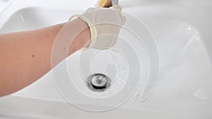 washing the sink with a sponge.Hygiene and cleanliness concept. Cleaning the bathroom.slow motion