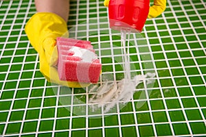 Washing the tiles in the bathroom