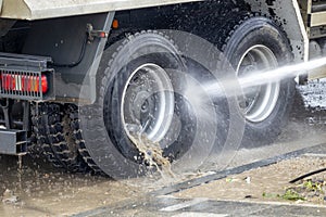 Washing truck wheels off dirt