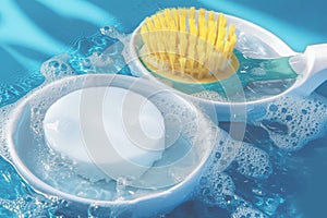 Washing utensils concept dishware and sponge soaked in water