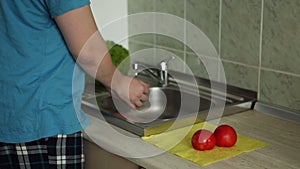 Washing vegetables in a sink in kitchen