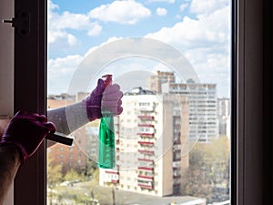 washing window in apartment in city building