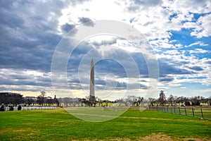 Washington DC, USA. View of Washington Monument area in black clouds and green field.