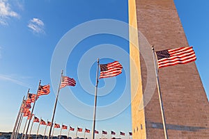 Washington Monument and American flags before sunset in US capital.