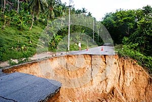 Washout: rain flood damaged badly washed out road in Thailand