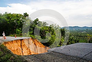 Washout: rain flood damaged badly washed out road in Thailand