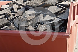 Waste asphalt pavement and concrete materials in container