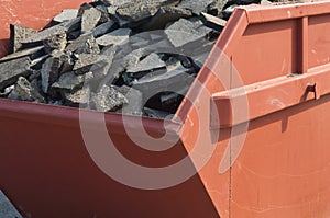 Waste asphalt pavement and concrete materials in container