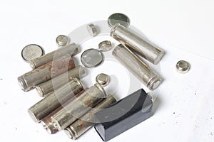Waste batteries of different types are scattered. On a white background.