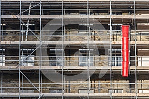 Waste chute on scaffolding