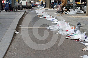 Waste in the city - pedestrians invaded by plastics from overconsumption photo