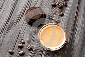 Waste coffee, cup of espresso on a black wooden background