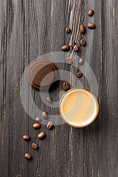 Waste coffee, cup of espresso on a black wooden background top view