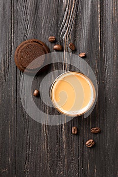 Waste coffee, cup of espresso on a black wooden background top view