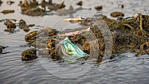 Waste during COVID19. Discarded ocean coronavirus face masks. Pollution