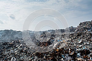 Waste at the garbage dump full of smoke, litter, plastic bottles,rubbish and trash at tropical island