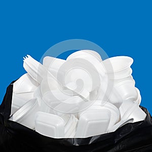 Waste Garbage foam food tray white many pile on the plastic black bag dirty isolated on blue background, Bin, Trash, Recycle, foam
