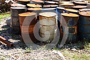 Waste ground with rusting oil drums.