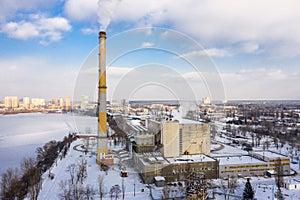 Waste incinerator plant with smoking smokestack at the winter. The problem of environmental pollution by factories