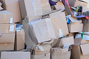 Waste paper and cardboardis collected and packaged for recycling in city. Pile of cardboard