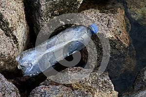 Waste plastic bottle at the river, Waste pollution, Garbage Trash plastic bottles empty on stone