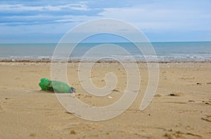 Waste plastic bottle on sand. Garbage on the beach