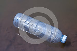 Waste plastic bottles float on the water surface, water pollution with garbage plastic, waste bottles plastic