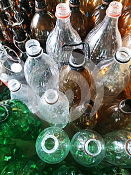 Waste plastic bottles and other types of plastic waste at a landfill. Photography: vertical recycling, photos of bottles made of
