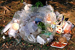 Waste plastic, Garbage, Dump, Pile Junk wet food waste plastic bags at the base of the tree, Waste polluting nature ecological