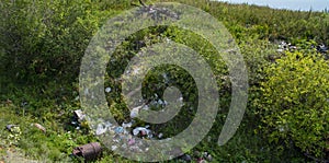 Waste in the ravine of metal, plastic and bottles