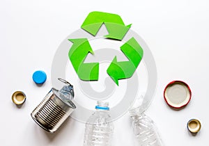 Waste recycling symbol with garbage on white background top view mock up