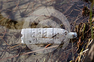 Waste and rubbish in the forest. Plastic bottles, cans and glass