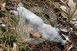 Waste and rubbish in the forest. Plastic bottles, cans and glass