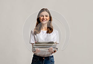 Waste Sorting. Portrait Of Beautiful Young Woman Holding Stack Of Old Magazines