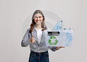 Waste Sorting. Smiling Young Female Carrying Container With Plastic Bottles For Recycling